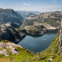 Lysenfjorden / Lyse fjord in Norway, seen from above, near Preikestolen, Norway. 600 meters lower a boat sails over the fjord